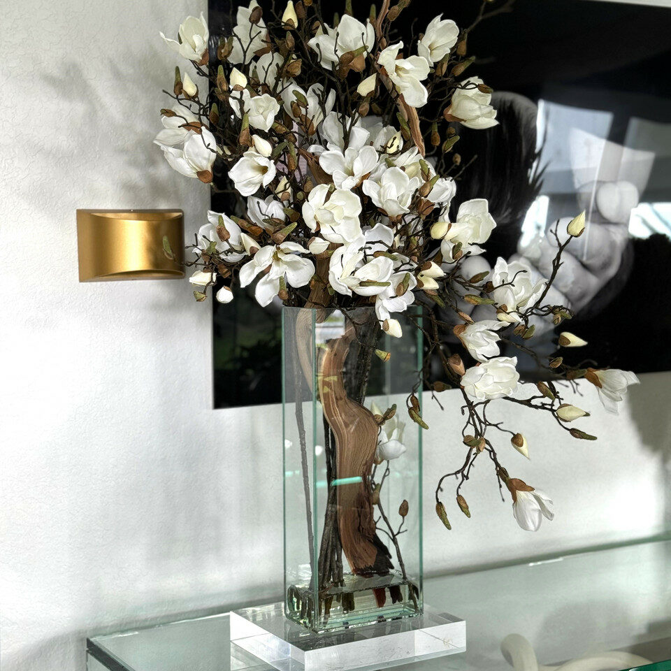 Cascading Magnolia Branch Arrangement in Tall Glass Cylinder