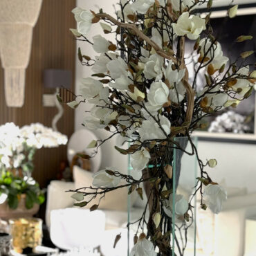 Cascading Magnolia Branch Arrangement in Tall Glass Cylinder
