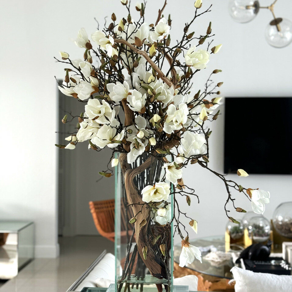 Cascading Magnolia Branch Arrangement in Tall Glass Cylinder