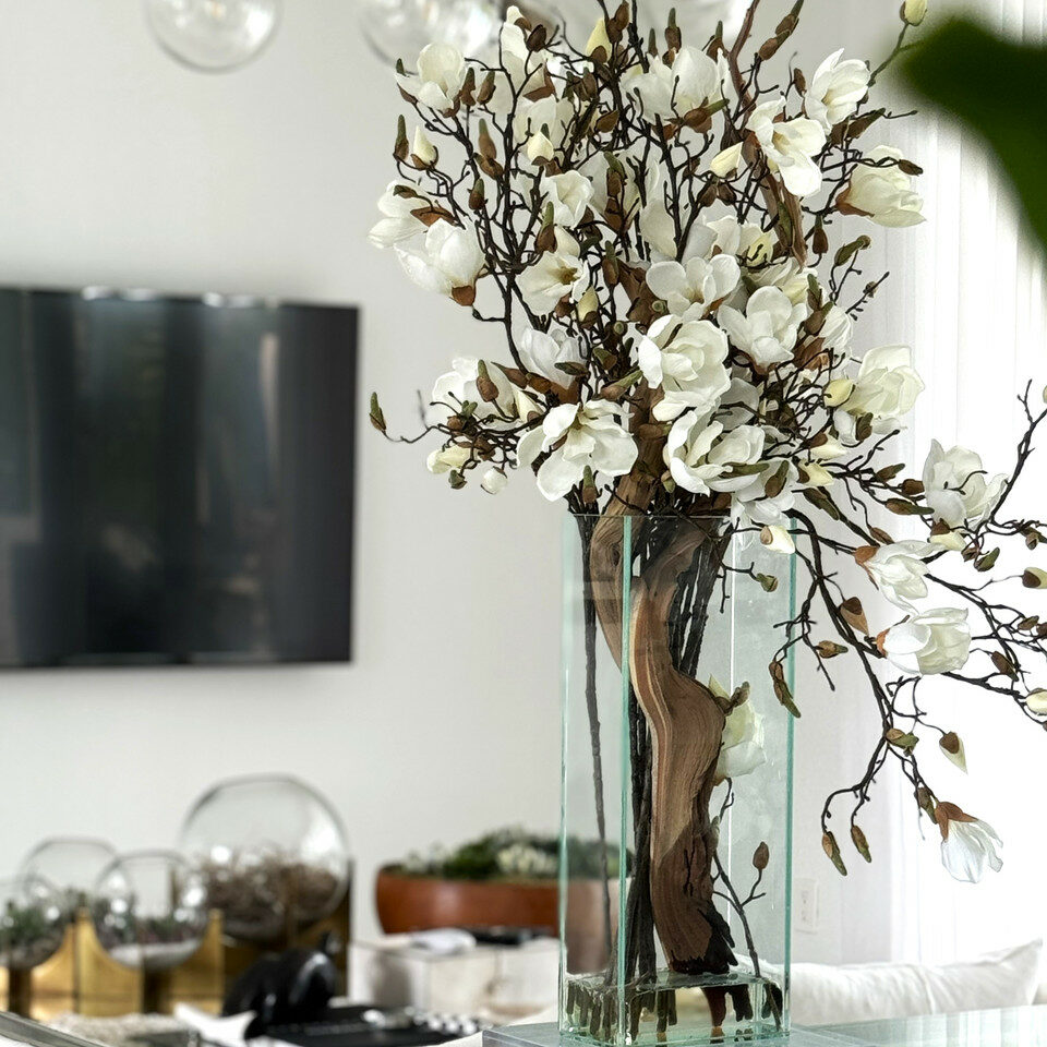 Cascading Magnolia Branch Arrangement in Tall Glass Cylinder